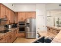 Charming kitchen includes stainless appliances, granite counters, wood cabinets, and a breakfast bar at 11000 N 77Th Pl # 2042, Scottsdale, AZ 85260