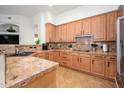Spacious kitchen showcases granite countertops, wood cabinets, stainless appliances, and tiled backsplash at 11000 N 77Th Pl # 2042, Scottsdale, AZ 85260
