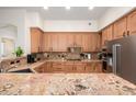 Well-equipped kitchen featuring granite countertops, stainless steel appliances, and ample wood cabinetry at 11000 N 77Th Pl # 2042, Scottsdale, AZ 85260