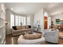 Bright living room featuring neutral tones, vaulted ceiling, modern furniture, and a dark-stained wood floor at 1243 W Sherri Dr, Gilbert, AZ 85233