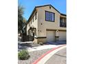 Well-maintained exterior view of the townhome, featuring a private entrance and an attached garage at 1265 S Aaron -- # 299, Mesa, AZ 85209