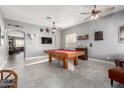 Spacious game room with a full-sized pool table, overhead fans, and plenty of space for entertaining at 12798 W Dove Wing Way, Peoria, AZ 85383