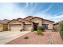 Charming single-story home with a three-car garage, low-maintenance landscaping, and inviting curb appeal at 12936 W Flower St, Avondale, AZ 85392
