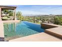 Stunning infinity pool overlooking picturesque desert landscape with distant mountain views at 15135 E Sundown Dr, Fountain Hills, AZ 85268