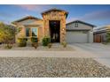 Beautiful single-Gathering home featuring low-maintenance landscaping and a welcoming front entrance, two-car garage at 16566 W Saguaro Park Ln, Surprise, AZ 85387