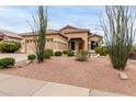 Inviting single-level home with a desert landscaped front yard, complemented by native plants and a two-car garage at 17132 E Hillcrest Dr, Fountain Hills, AZ 85268