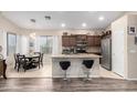 Open kitchen showcasing granite countertops, stainless appliances, and a breakfast bar with bar stools at 17132 E Hillcrest Dr, Fountain Hills, AZ 85268