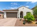 Charming single-story home featuring a two-car garage and a well-maintained, drought-resistant landscaped front yard at 18422 W Clinton St, Surprise, AZ 85388
