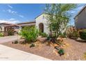 Charming single-story home featuring a two-car garage and a well-maintained, drought-resistant landscaped front yard at 18422 W Clinton St, Surprise, AZ 85388