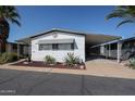 Charming single-story home featuring a covered carport and well-maintained desert landscaping at 205 S Higley Rd # 286, Mesa, AZ 85206