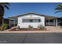 Charming single-story home featuring a covered carport and well-maintained desert landscaping at 205 S Higley Rd # 286, Mesa, AZ 85206