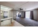 Inviting living room featuring gray walls, neutral carpet and a ceiling fan at 205 S Higley Rd # 286, Mesa, AZ 85206