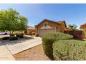 Single-Gathering home with desert landscaping, a two-car garage and a fenced backyard at 2140 S Benton Cir, Mesa, AZ 85209