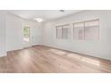 Bright living room featuring hardwood floors, and abundant natural light from multiple windows at 2140 S Benton Cir, Mesa, AZ 85209