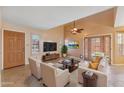 Bright living room featuring high ceilings, neutral decor, plantation shutters, and french doors at 2455 E Broadway Rd # 68, Mesa, AZ 85204