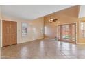 A spacious living room with tile flooring, featuring high ceilings and natural light at 2455 E Broadway Rd # 68, Mesa, AZ 85204