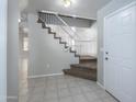 Inviting entryway featuring a staircase with white railing and tiled flooring for a clean, modern look at 24709 N 75Th Way, Scottsdale, AZ 85255