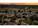 Expansive aerial view showcases a residential neighborhood with well-maintained homes, landscaping, and desert views at 2565 N 141St Ln, Goodyear, AZ 85395