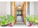 Inviting entryway featuring a wooden front door, tile flooring, and views into the bright living area at 2565 N 141St Ln, Goodyear, AZ 85395