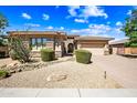Inviting single-Gathering home with well-kept desert landscaping, stone accents, and a spacious three-car garage at 2565 N 141St Ln, Goodyear, AZ 85395