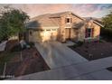 Beautiful single-Gathering home boasting a stone facade, ample driveway space, and well-maintained landscaping at 2727 N Acacia Way, Buckeye, AZ 85396