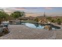 Gorgeous private backyard oasis, complete with pool, waterfall, and desert landscaping at 31703 N 15Th Dr, Phoenix, AZ 85085
