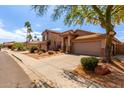 Desert home boasting a terracotta roof and an inviting stone-accented entrance at 3207 E Behrend Dr, Phoenix, AZ 85050