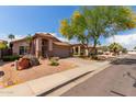 Beautiful home with desert landscaping, stone accents, and a well-maintained lawn at 3207 E Behrend Dr, Phoenix, AZ 85050