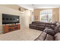Comfortable living room with plush leather seating and natural light at 3207 E Behrend Dr, Phoenix, AZ 85050