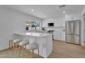 Modern kitchen featuring stainless steel appliances, white cabinets, and barstool seating at 3307 N Apollo Dr, Chandler, AZ 85224
