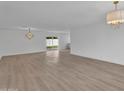 Spacious living room with new laminate flooring and modern light fixtures at 3307 N Apollo Dr, Chandler, AZ 85224