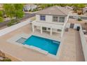 An aerial view of the backyard featuring a beautiful pool, and covered patio, showcasing the property's outdoor space at 3841 E Esplanade Ave, Gilbert, AZ 85297