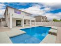 Inviting backyard pool with a covered patio and lush landscaping perfect for entertaining and enjoying the outdoors at 3841 E Esplanade Ave, Gilbert, AZ 85297