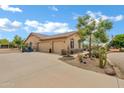 This property features an oversized three car garage, water fountain, and mature desert landscaping at 4187 E Triple Crown Dr, San Tan Valley, AZ 85140