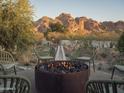 Relaxing firepit surrounded by chairs, set against a stunning mountain backdrop, creating an inviting outdoor space at 4747 E Arroyo Verde Dr, Paradise Valley, AZ 85253