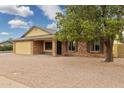 View of the home's charming brick facade, two car garage, and neutral landscaping at 4854 E Evergreen St, Mesa, AZ 85205