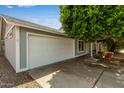 Single Gathering home with a two-car garage, mature trees and covered entry way at 5923 W Mauna Loa Ln, Glendale, AZ 85306