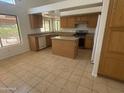 An open kitchen includes a large island, stainless steel appliances and granite countertops at 6416 N 78Th Ln, Glendale, AZ 85303