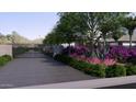Beautifully landscaped driveway featuring flowering bushes and a secure gate at 6649 E Ocotillo Rd, Paradise Valley, AZ 85253