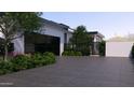 Well landscaped driveway leading to a modern home featuring large windows and secure gate at 6649 E Ocotillo Rd, Paradise Valley, AZ 85253