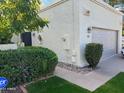 Home exterior featuring desert landscaping, a two-car garage, and warm toned stucco at 703 E Corte Oro --, Phoenix, AZ 85020