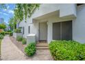 Inviting front entrance with a decorative door, manicured landscaping, and a welcoming pathway at 7272 E Gainey Ranch Rd # 117, Scottsdale, AZ 85258