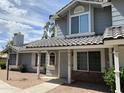 View of a charming two-story home featuring arched windows, tile roof, and an inviting covered entryway at 860 N Mcqueen Rd # 1058, Chandler, AZ 85225