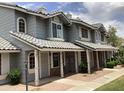 Charming two-story home featuring arched windows, tile roof, and covered entryways for a welcoming curb appeal at 860 N Mcqueen Rd # 1058, Chandler, AZ 85225