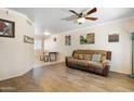 Comfortable living room boasting a ceiling fan, neutral walls, and wood-look tiled flooring at 860 N Mcqueen Rd # 1058, Chandler, AZ 85225