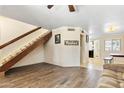 Open-concept living area features wood-look tile floors, a staircase and view to dining room at 860 N Mcqueen Rd # 1058, Chandler, AZ 85225