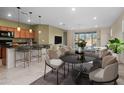 Open concept with dining area and a sleek black table and modern chairs at 11626 E Yeager Cyn, Gold Canyon, AZ 85118