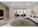 Bright living room showcasing a stylish white sectional and scenic backyard views through sliding glass doors at 11626 E Yeager Cyn, Gold Canyon, AZ 85118