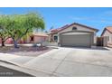 Inviting single-story home with a two-car garage and desert landscaping, perfect for curb appeal at 13443 W Post Dr, Surprise, AZ 85374