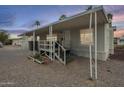 Mobile home featuring an inviting covered porch and ample parking at 156 N Hawes Rd # 68, Mesa, AZ 85207